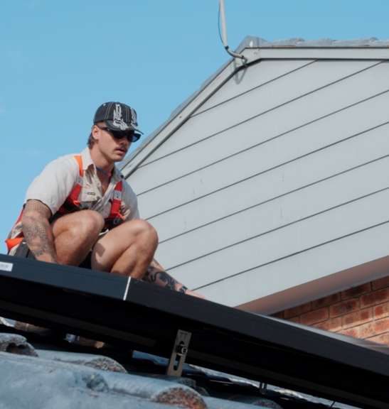 Elite Energy technician installing solar panels